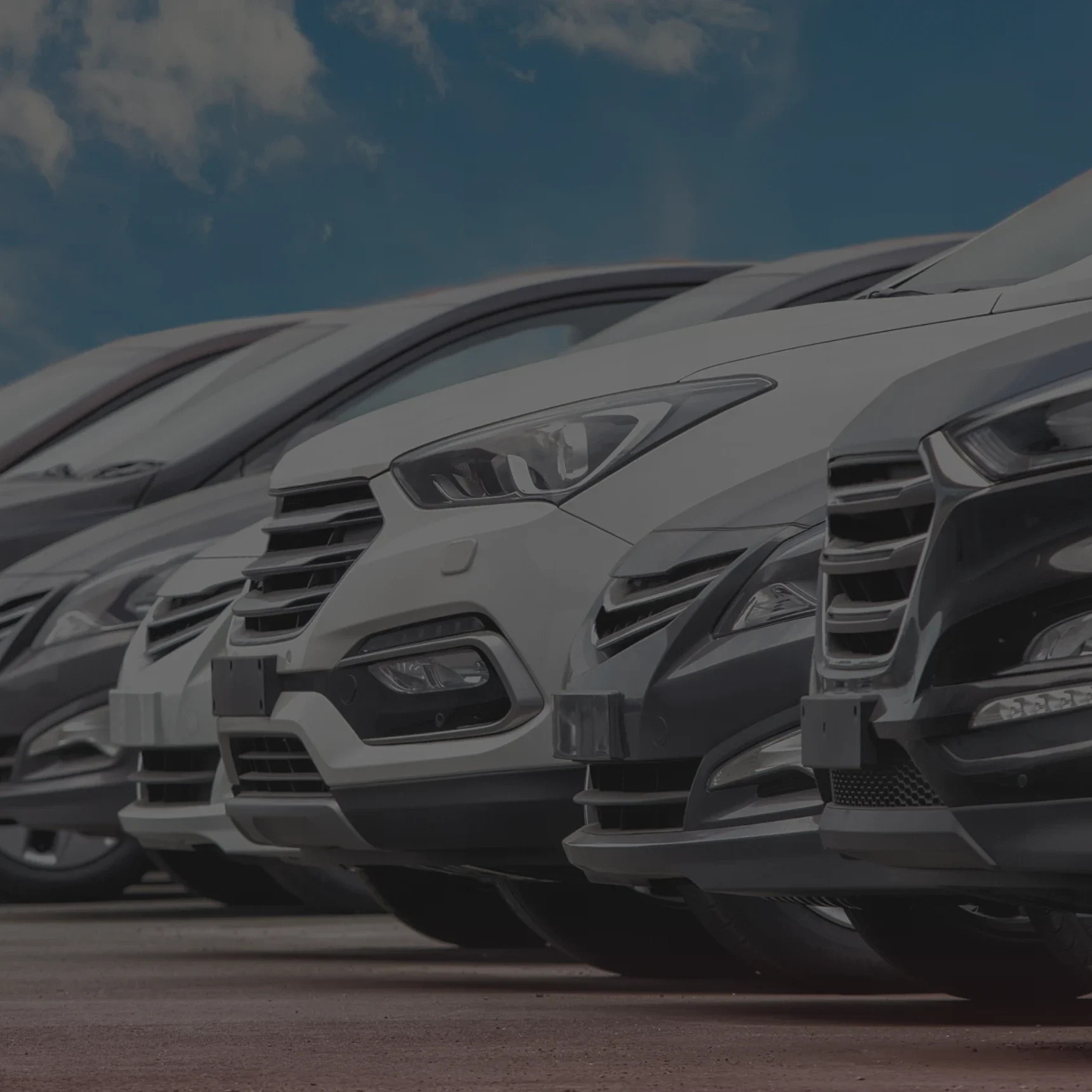 Row of parked cars under blue sky